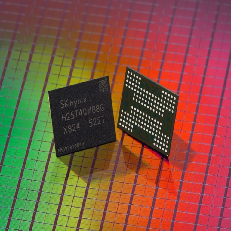Two computer chips are placed on a colorful semiconductor wafer background. One chip is black with text, and the other has an array of small white dots.